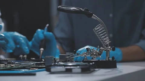 Technician using soldering iron on electronic circuit board for hardware re.. Stock Footage 345606067