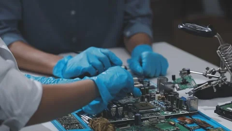 Technician using soldering iron on electronic circuit board for hardware re.. Stock Footage 345606071