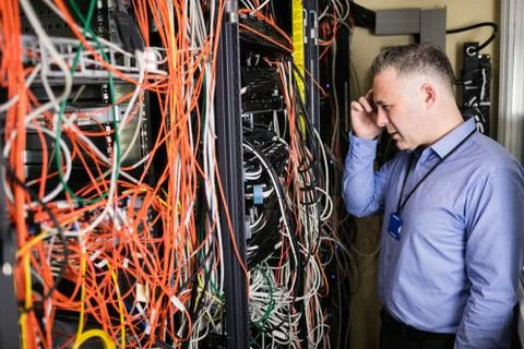 Technician using tablet pc while analysing server Stock Photos