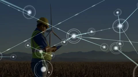 Technician using tablet in wind farm checking turbine, starting nodes and lines Stock Footage 332544737