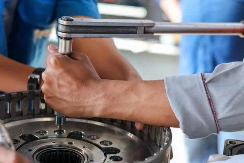 Technician Using Torque Wrench On Mechanical Assembly. Stock Photos