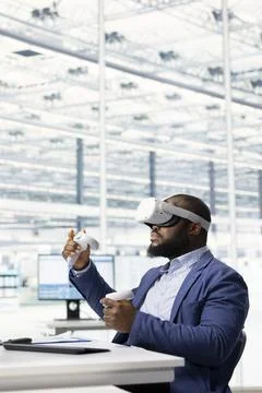 Technician using VR goggles gear to do microchip yield enhancement Stock Photos
