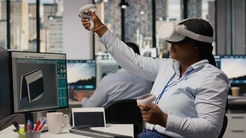 Technician using VR headset to create solar powered device design Stock Photos