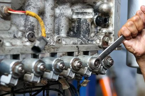 Technician Using Wrench On Engine Transmission Solenoid Valve. Stock Photos