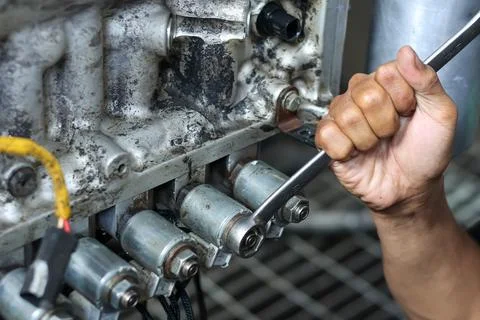 Technician Using Wrench On Engine Transmission Solenoid Valve. Stock Photos