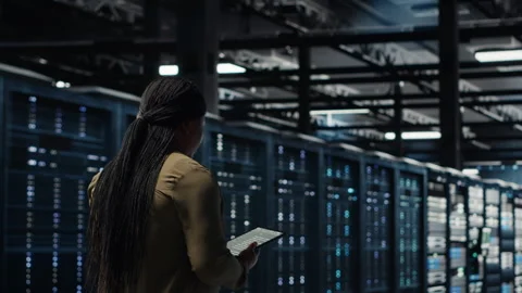 Technician walking in data center, using app on tablet to ensure error free rigs Stock Footage 317207124