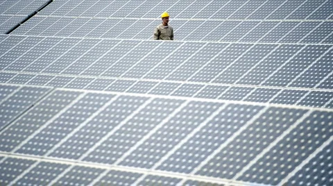 Technician walking through  solar panels Stock Footage 2975786