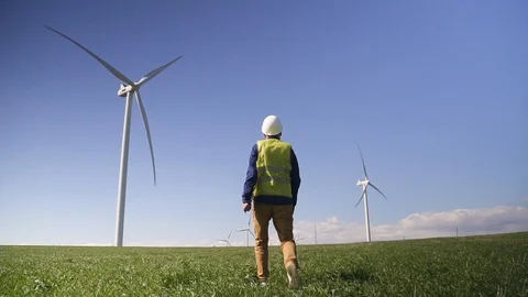Technician walking to wind mill and monitoring system performanc Video stock 113998968