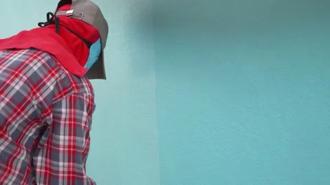 The technician was using a blue paint roller on the wall. Stock Footage 148674483