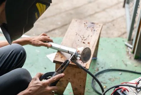 Technician welding foot adjustable table. Stock Photos