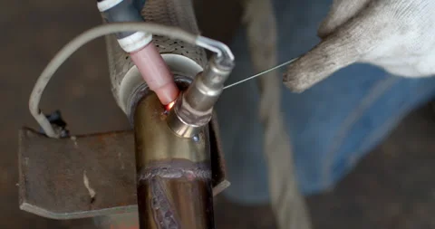 Technician is welding pipe to add position of o2 sensor.Car pipe welding. Stock Footage 304102594