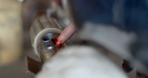Technician is welding pipe to add position of o2 sensor.Car pipe welding. Stock Footage 316591442