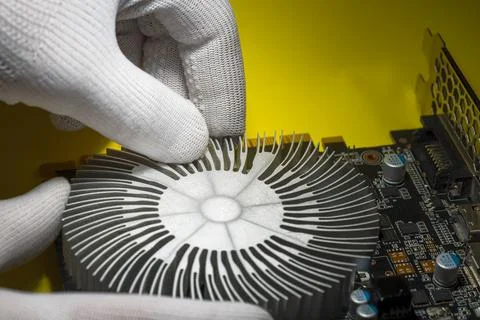 A technician in white antistatic gloves assembling cooling radiator Stock Photos