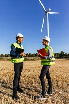 Technician of wind turbines standing while planning the installation of new Stock Photos