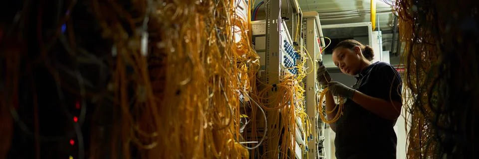 Technician Wiring Network Cables in a Server Room Stock Photos