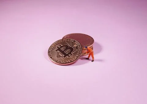 Technician worker figure standing in front of bitcoin. Bitcoin mining concept Stock Photos