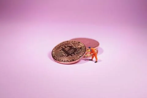 Technician worker figure standing in front of bitcoin. Bitcoin mining concept Stock Photos