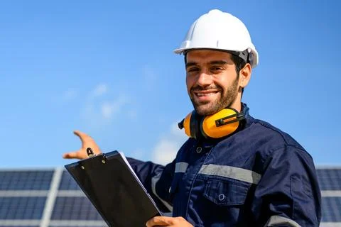 Technician worker installing solar panels at solar cell farm Stock Photos