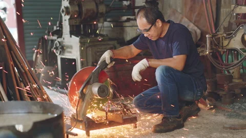 Technician worker use metal cutting machine and sparks in workshop factory Stock Footage 204055165