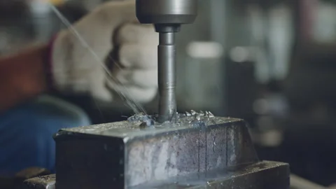 Technician worker using drilling machine for metalworking in workshop factory Stock Footage 204054694