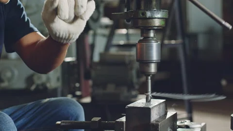 Technician worker using drilling machine for metalworking in workshop factory Stock Footage 204054716