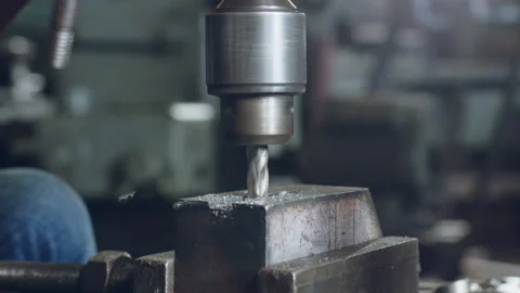 Technician worker using drilling machine for metalworking in workshop factory Stock Footage 204054819