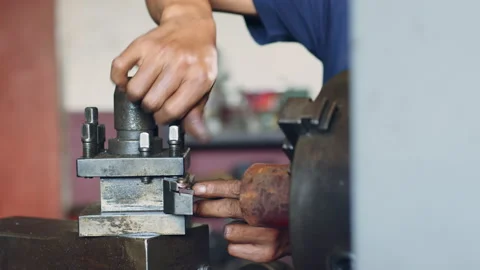 Technician worker using turning lathe machine for metalworking in factory Stock Footage 204054081