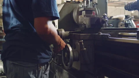 Technician worker using turning lathe machine for metalworking in factory Stock Footage 204054150