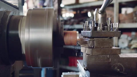 Technician worker using turning lathe machine for metalworking in factory Stock Footage 204054254