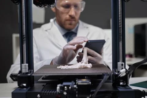 Technician Working on 3D Bone Prototype Foto stock