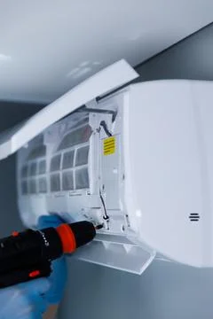 Technician Working on Air Conditioning Unit Maintenance and Repair with Electric Stock Photos