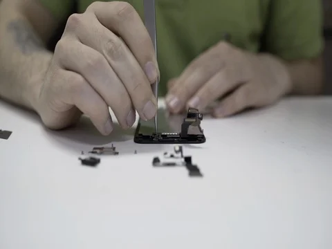 Technician working with broken smartphone for refreshing. 4K Close up Stock Footage 79837300