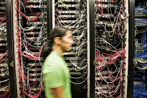 Technician working on a CAT 5 cable bundling system in a computer server room. Stock Photos