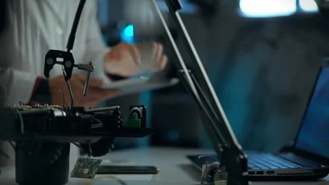 Technician working on a circuit board with tools in a laboratory during the Stock Footage 289572943