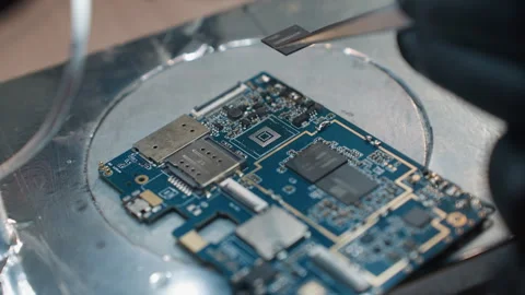 Technician Working on Circuit Board Under Microscope with Chip Removed Stock Footage 281375281