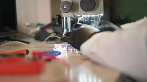 Technician Working on Circuit Under Microscope in Lab Stock Footage 282298598