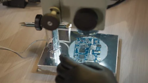 Technician Working on Circuit Under Microscope in Lab Stock Footage 282648981