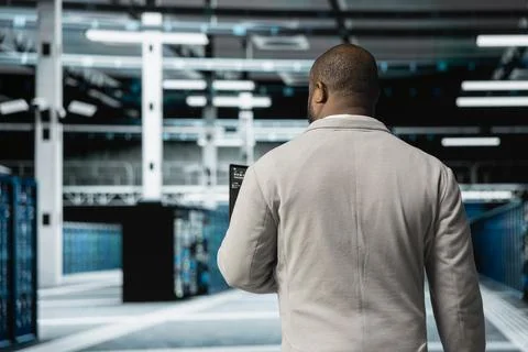 Technician working in data center overseeing international user traffic Stock Photos