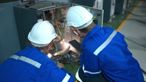 Technician working on the electrical control cabinet of robotic arm, Stock Footage 262763743