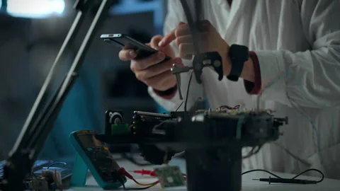 Technician working on electronic device assembly in a modern laboratory sett Stock Footage 289573105