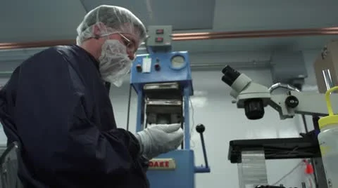 Technician Working in front of Microscope in Cleanroom Stock Footage 10895796