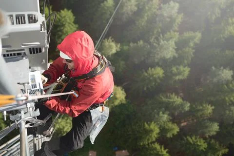 Technician Working at Height on a 5g Telecom Tower 写真素材