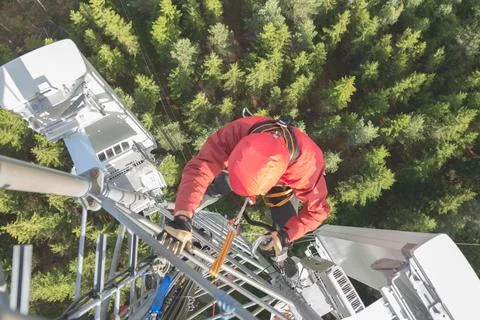 Technician Working at Height on a 5g Telecom Tower 写真素材