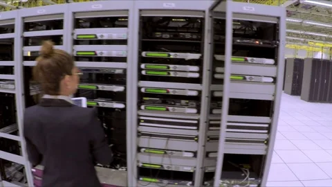 Technician Working Inside Modern Data Center with Server Rack Infrastructure Stock Footage 338133007