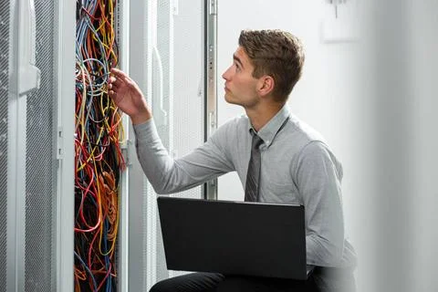  Technician working on laptop in hallway of server room Portrait of modern... Stock-Fotos