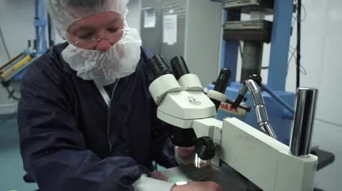 Technician working at Microscope in Cleanroom Stock Footage 10895920
