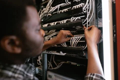 Technician working on network server installation in a data center during the Stock Photos