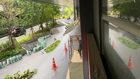 Technician working outside store front fixing and maintain retail shop sign Stock Footage 249033544