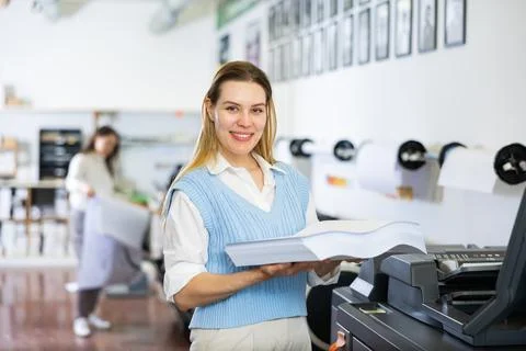 Technician working on plotter and cutter machine in printing shop Stock Photos