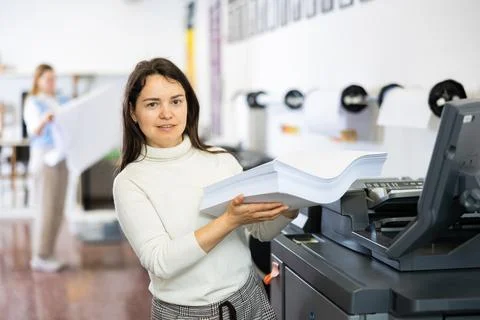 Technician working on plotter and cutter machine in printing shop Fotos de archivo